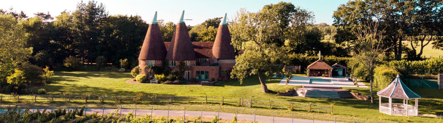 The oasthouse and gardens with surrounding countryside at Oastbrook Vineyard